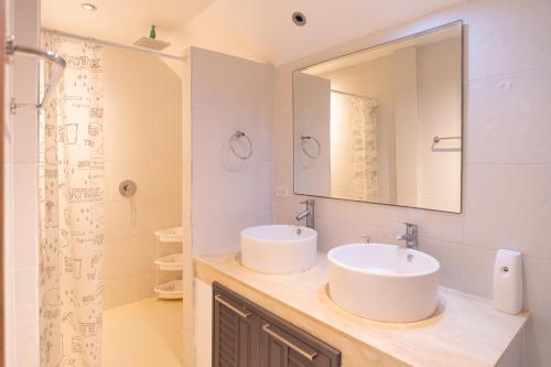 a bathroom with two sinks and a mirror at JUNGLE APARTMENT2 BEDROOMS PRIVATE POOl in Kamala Beach