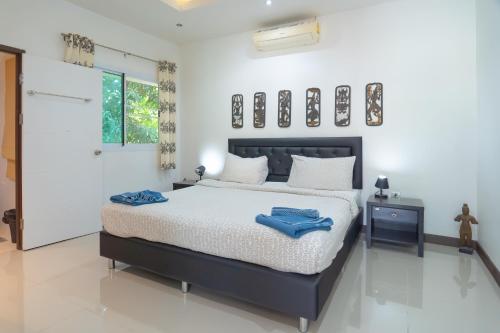 a bedroom with a bed with blue towels on it at JUNGLE APARTMENT2 BEDROOMS PRIVATE POOl in Kamala Beach