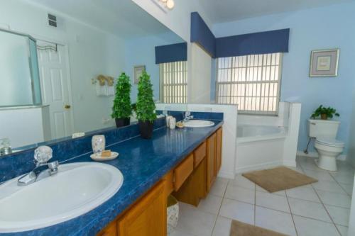 a bathroom with two sinks and a blue counter at Home With A View! in Orlando