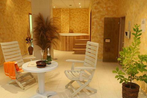 a living room with a table and chairs and plants at Elias Apartment in Golden Sands