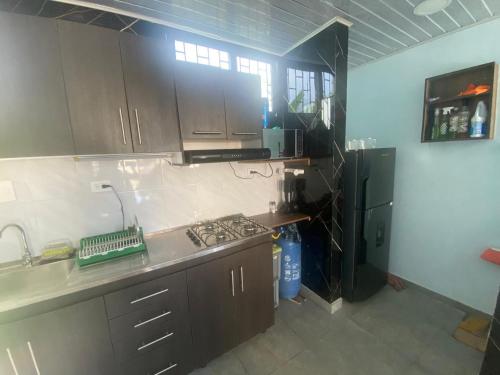 a kitchen with a stove and a refrigerator at El Castillo in Moñitos