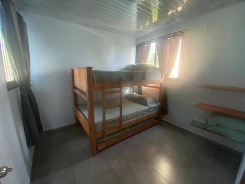 a bedroom with two bunk beds in a room at El Castillo in Moñitos
