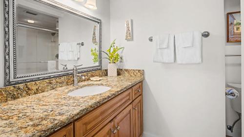 a bathroom with a sink and a mirror at Beachcrest 805 in Santa Rosa Beach
