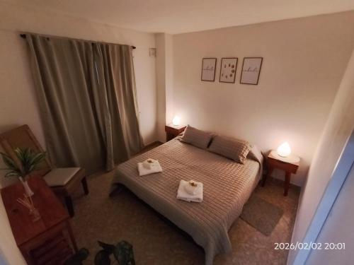 a bedroom with a bed with two towels on it at departamento completo, Luminoso, cómodo y bien ubicado ideal eventos river movistar arena tecnopolis in Munro