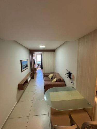 a living room with two couches and a table at Flat beira mar Olinda Jam in Olinda