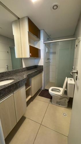 a bathroom with a toilet and a sink at Flat beira mar Olinda Jam in Olinda