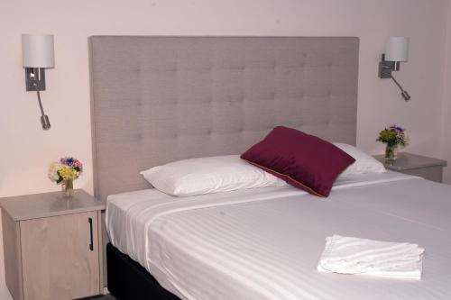 a bedroom with a large bed with a large headboard at Manjimup Motor Inn in Manjimup