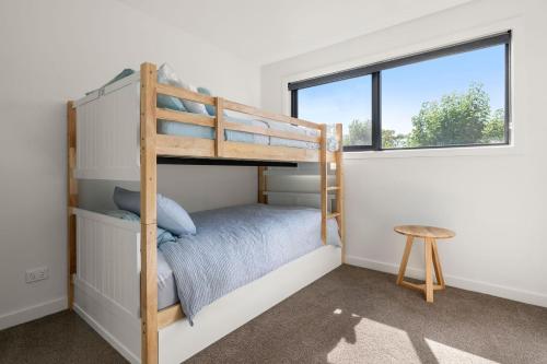 a bedroom with a bunk bed and a window at Coastal Ember in Inverloch