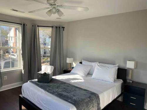 a bedroom with a large bed with a ceiling fan at 25 Lux Room 3 - 1 Queen Bed, Shared Bathroom - Nonsmoking in Arlington