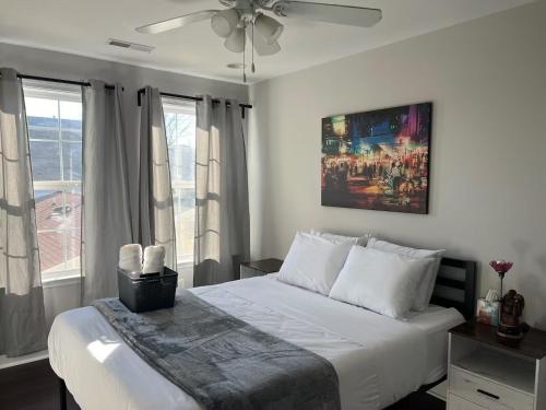 a bedroom with a white bed with a ceiling fan at 25 Lux Room 2 - 1 Queen Bed, Shared Bathroom - Nonsmoking in Arlington