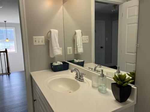 a bathroom with a sink and a mirror at 25 Lux Room 3 - 1 Queen Bed, Shared Bathroom - Nonsmoking in Arlington