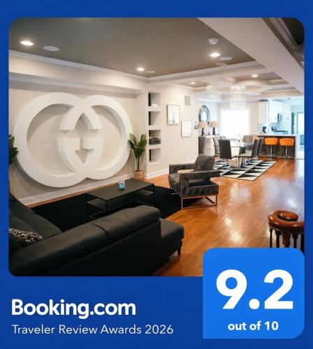 a living room with a large logo on the wall at Charm City Luxury 4 Bedroom Brick Home in Baltimore