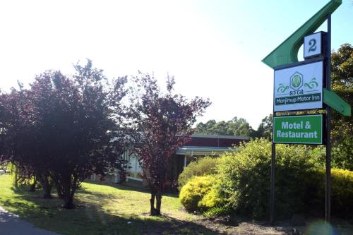 a sign for a motel and restaurant in front of a building at Manjimup Motor Inn in Manjimup