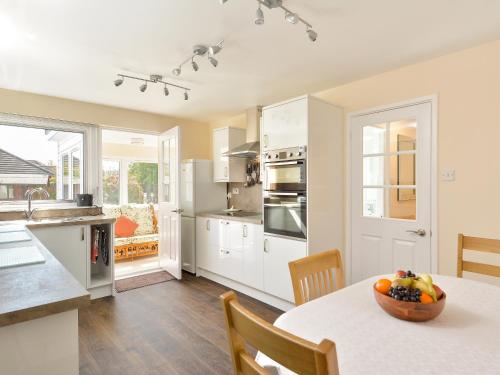 a kitchen with a table with a bowl of fruit on it at Westburn in Comrie