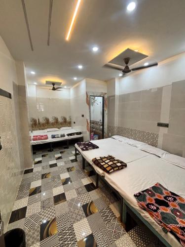 a room with two beds and a mirror at HOTEL IN UJJAIn in Ujjain