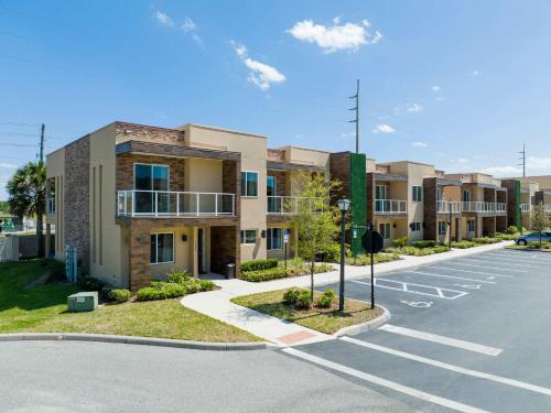 an empty parking lot in front of an apartment complex at Stunning 4 Bd Close To Disney @ Magic Village 3247 in Orlando