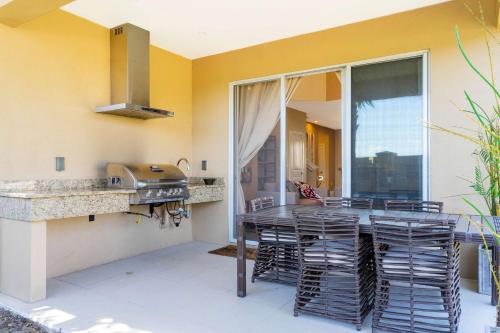 a kitchen with a table and chairs and a sink at Stunning 4 Bd Close To Disney @ Magic Village 3247 in Orlando