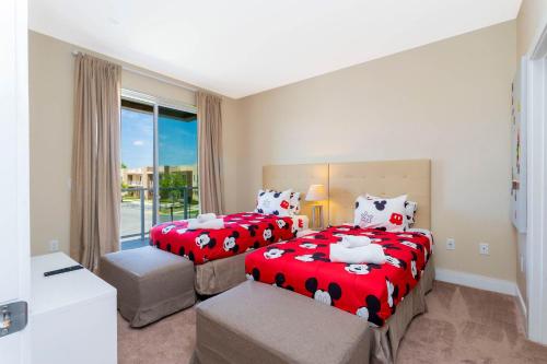 a bedroom with two beds and a window at Stunning 4 Bd Close To Disney @ Magic Village 3247 in Orlando