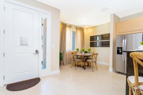 a kitchen and dining room with a table and chairs at Stunning 4 Bd Close To Disney @ Magic Village 3247 in Orlando