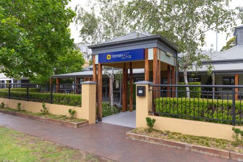 a bus stop in front of a building at Mandala Signature Berry in Berry