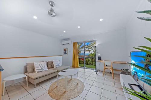 a living room with a couch and a table at PET FRIENDLY Coolview in Cannonvale