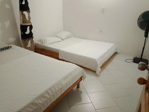a room with two beds and a fan at WalApar in San Rafael