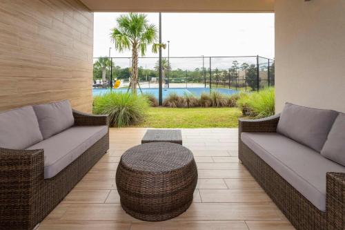 a patio with two couches and a table and a pool at Gorgeous 4Bd Close to Disney @ Magic Village 7581 in Orlando