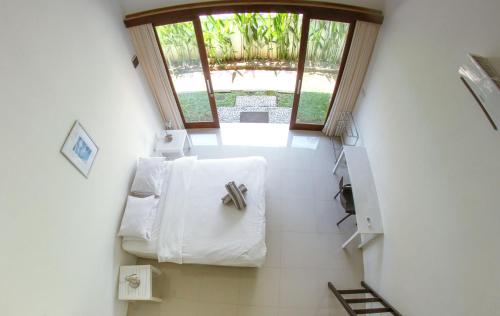 a view of a bathroom with white towels at Canggu Beach Inn in Canggu