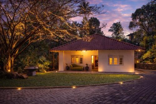 a house with a patio and a driveway at Heuvel Villa Kandy in Kandy