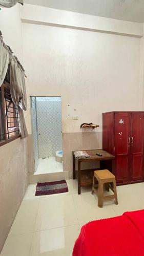 a bathroom with a shower and a table in it at Homestay Yaa Syafi in Bireun