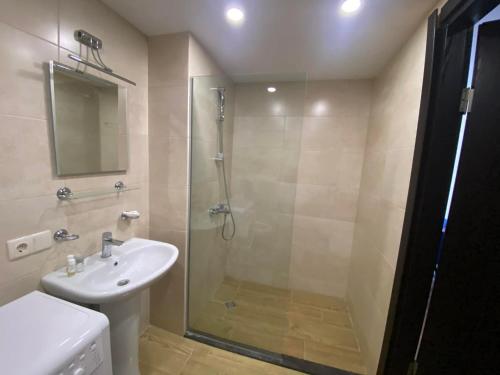 a bathroom with a shower and a sink at Frostwood Residence Orbi in Bakuriani