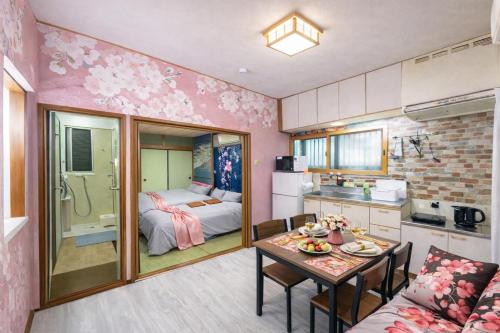a kitchen and a living room with a table in a room at 1200IN&OUT 4people 35m2 2Queenbed! 1sofabed! Exclusive house Shinjuku 18 minutes Shibuya 22 minutesIkebukuro 11 minutes in Tokyo
