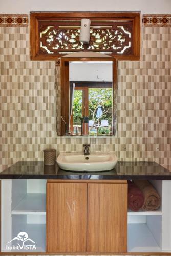 a bathroom with a sink and a mirror at The Bingin Green View by Bukit Vista in Uluwatu