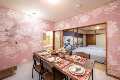 a dining room with a table and a bedroom at 1200IN&OUT 4people 35m2 2Queenbed! 1sofabed! Exclusive house Shinjuku 18 minutes Shibuya 22 minutesIkebukuro 11 minutes in Tokyo