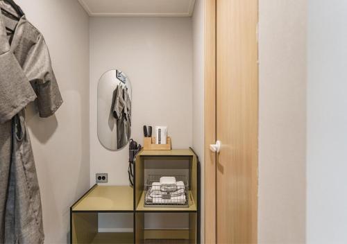 a dressing room with a mirror and a glass table at Incheon Juan Chungchoon Hotel in Incheon