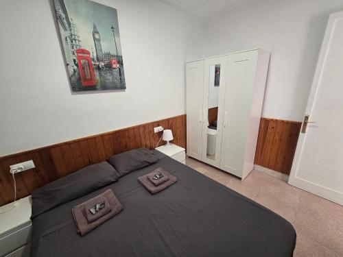 a bedroom with a bed with two pillows on it at Chalet Ebro barbacoa in Riba-roja d'Ebre