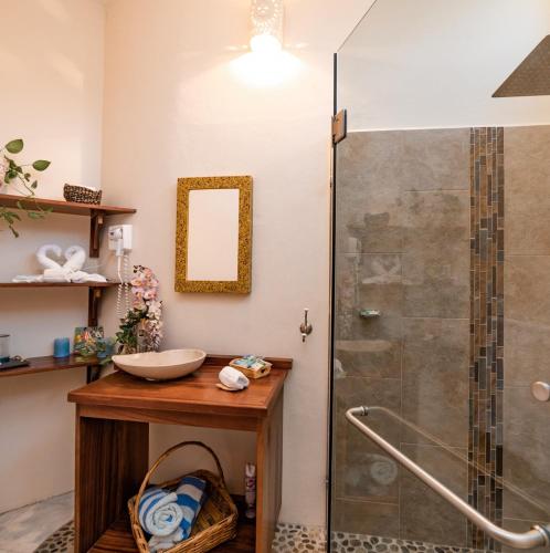 a bathroom with a sink and a shower at Villa de Dos Armadillos in Santa Maria Huatulco
