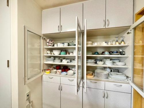 a kitchen with white cabinets and plates and dishes at YUKARA-YA YA - Vacation STAY 18011 in Ōnuma
