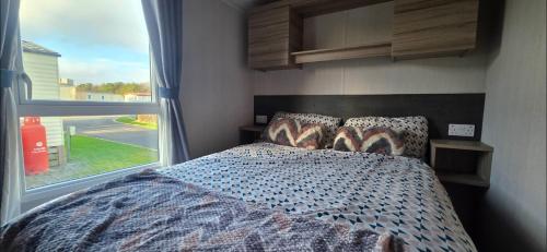 a bedroom with a bed with a large window at Mason's Morecambe Memories in Heysham