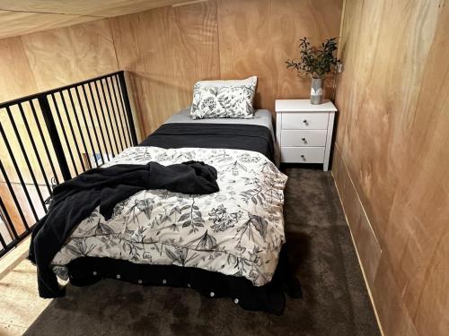 a small bedroom with a bed and a night stand at Barn Apartment in Earnscleugh