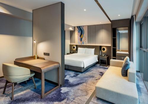 a hotel room with a bed and a desk at Hyatt Place Busan Yeonsan in Busan