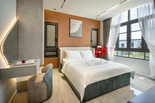 a bedroom with a large bed and a large window at Golden Terra Villa in Phan Thiet