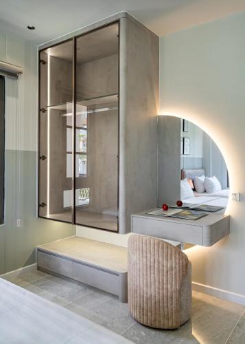 a living room with a bed and a chair at Golden Terra Villa in Phan Thiet