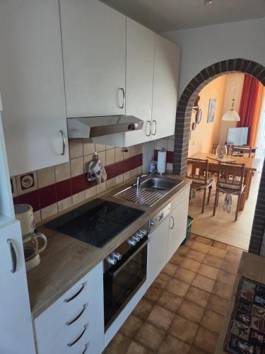 a kitchen with a sink and a stove top oven at up ` Achterdeck in Dornum
