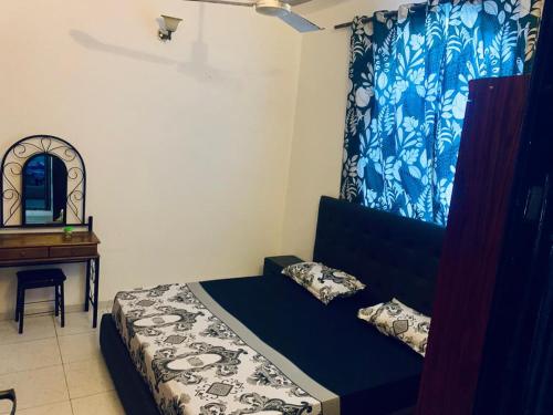 a bedroom with a bed and a desk and a mirror at Brise de Mer 2 Bedrooms in Djibouti