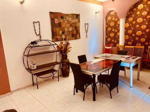 a dining room with a glass table and chairs at Brise de Mer 2 Bedrooms in Djibouti