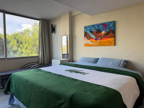 a bedroom with a large bed and a window at Suites en la zona más cool in Guadalajara