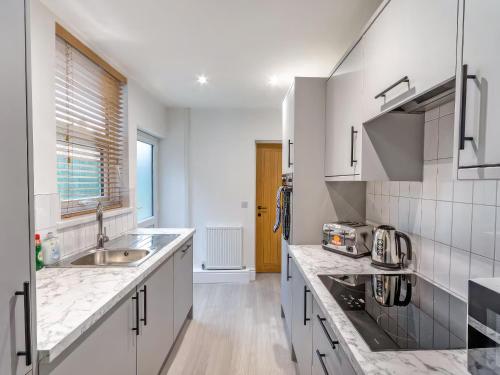 a kitchen with a sink and a counter top at Woods Terrace in Gainsborough