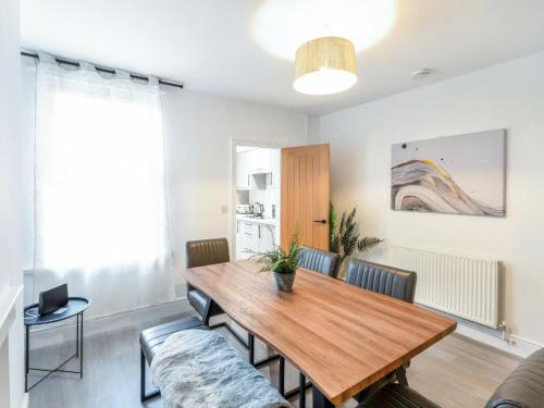 a dining room with a wooden table and chairs at Woods Terrace in Gainsborough