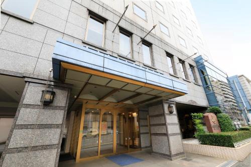 a building with a revolving door in front of it at Yokohama Mandarin Hotel in Yokohama